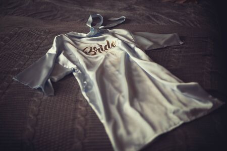 A blue pajama on which the bride writes sits on the bedの写真素材