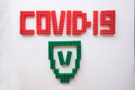 description covid-19 of the constructor blocks on the white backgroundの写真素材