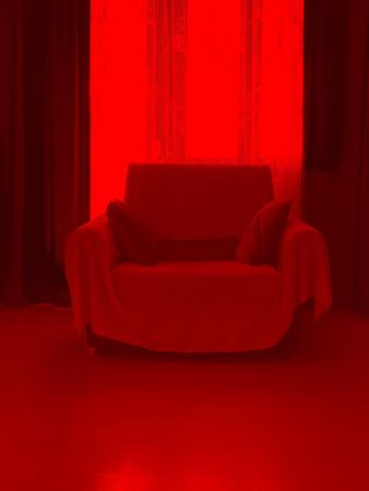 Armchair in red roomの写真素材