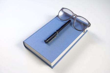 Book with eyeglasses and pencilの写真素材
