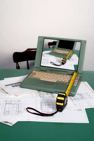 Architecture planning with metre and laptop on desk - focus on first planeの写真素材