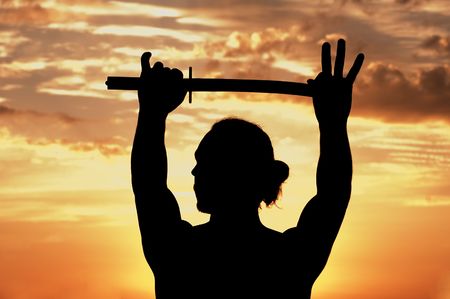 Man with sword in sunsetsの写真素材