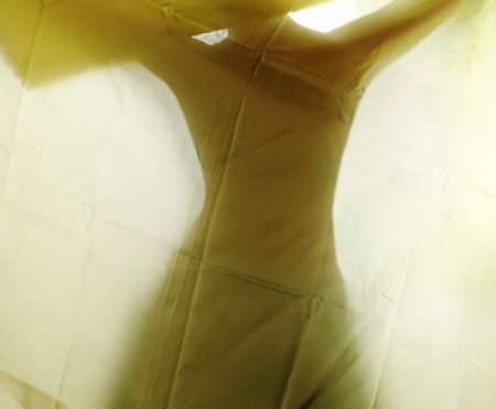 Woman's silhouette of dancing behind texture of textileの写真素材