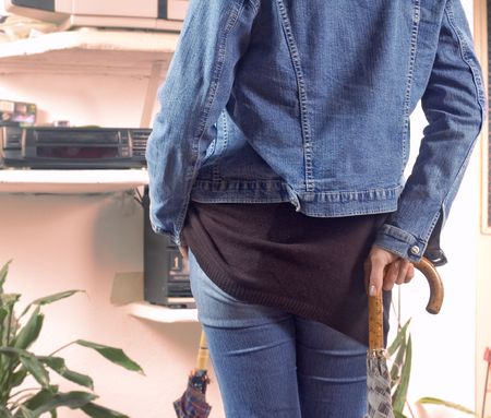 Back view of young girl standing in front of video playerの写真素材