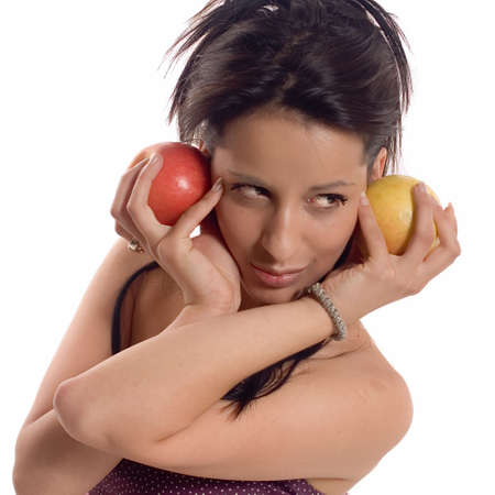 Young brunette girl posing and eating a appleの写真素材