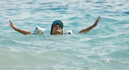 Young female child swimming on the seaの写真素材