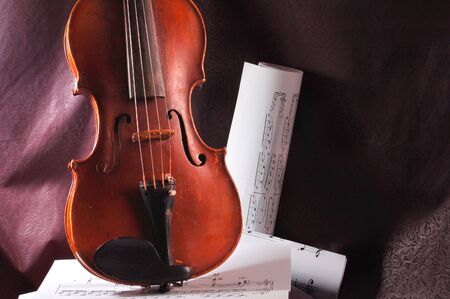 Violin and musical note on sheet of paperの写真素材