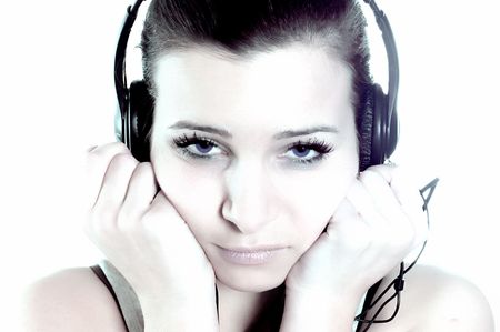 Young female singing and listening to music with stereo headphonesの写真素材
