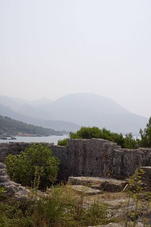 Shot of part of ruins castle on beach of sea Adriaticの写真素材