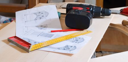 Carpentry's tools on bench with planning of the doors