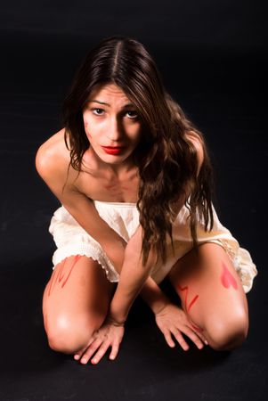 Smearing make up on the body of young girl with strong lighting contrastの写真素材