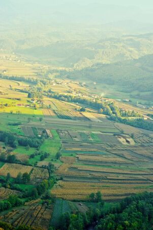 Panorama agricultures cornfields and meadows with rural houses in serbia, airy atmosphere