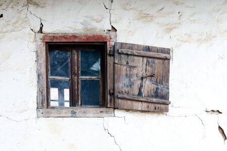 Old wooden window and wall of mudの写真素材