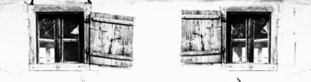 Two old wooden windows and wall of mud