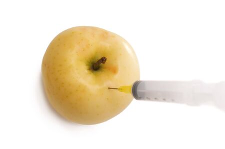 An apple with syringe insertedの写真素材
