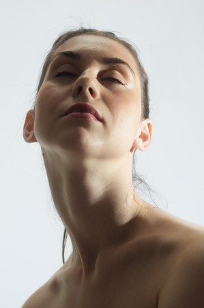 Portrait of a young, beautiful caucasian woman with long neck,beauty treatment concept with eyes closedの写真素材