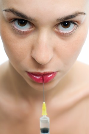 Woman getting botox injection or hyaluronic, collagen,HA injection in lipsの写真素材
