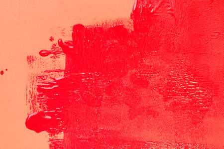 Painting with red grunge color over a orange wall.の写真素材