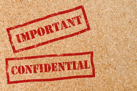 Stamp with "Confidential" and"Important" text on texture of woodの写真素材