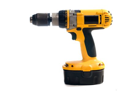 Yellow hand electric drill on battery chargerの写真素材