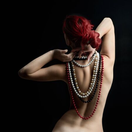 Beautiful woman wearing pearls around her neck, back viewの写真素材