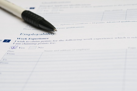 Pen and application form for work experience that requires to fill out his required information.