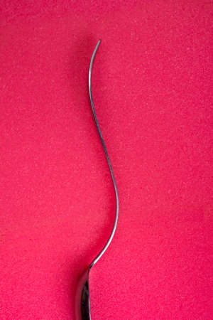 Female human figure from bent spoon on red spongy backgroundsの写真素材
