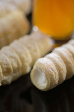 Delicious stack of roll cakes on wooden table, macro shootingの写真素材