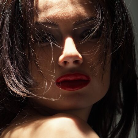 Portrait young woman on blackの写真素材