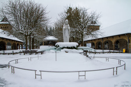 Banneux, Belgium, Statue of the Virgin Mary under the snow. Banneux is a place of pilgrimage in Belgium where the Virgin Mary appeared there to Mariette Beco in 1933.のeditorial素材