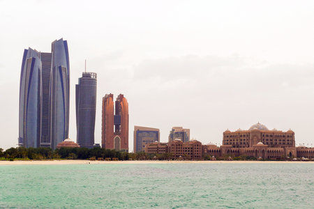 Abu Dhabi, United Arab Emirates, April 13, 2019. modern buildings seen from the beachのeditorial素材