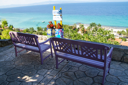 Afitos, Greece, July 9 2021. .Greece, Afitos, Bench in front of Afitos beachのeditorial素材