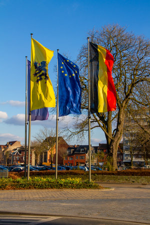 Hasselt, Belgium, March 7, 2021. Flemish, Belgian and European flag on a roundabout.のeditorial素材