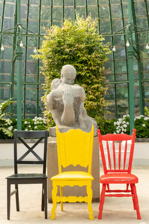 Brussels, Belgium, May 4, 2022, hree chairs in the colors of the Belgian flag in the greenhouses of the royal castle of Laekenのeditorial素材