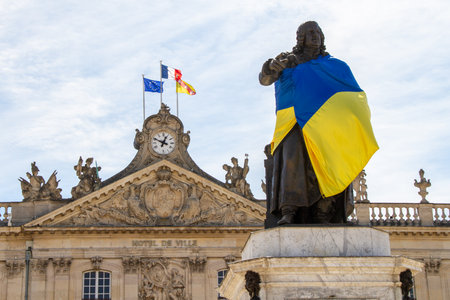 Nancy, France, April 18, 2022. Solidarity with Ukraine at war with Russia. Statue of Stanilas with the Ukrainian flag.のeditorial素材