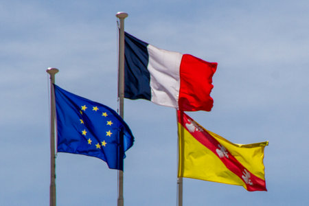 Nancy, France, April 18, 2022. Three flags, European flag, French flag and Lorraine flag on the roof of the town hall.のeditorial素材