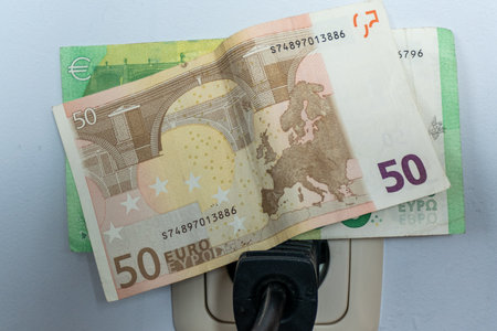 Asse, Belgium, September 17, 2022. Energy prices, electricity, plug, with euro banknotes