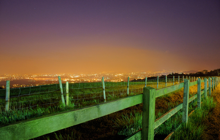 Fence and city lightの写真素材