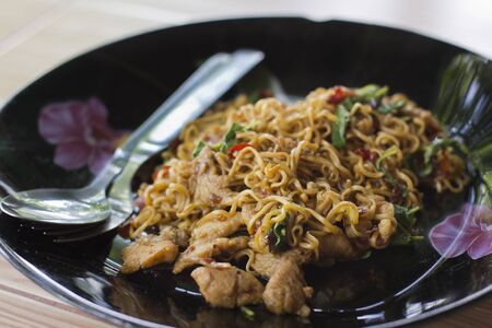 Fried instant noodle with spicy sauce and holy basilの写真素材