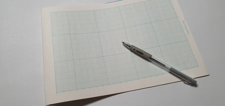 a sheet of paper and a pen for drawing.
