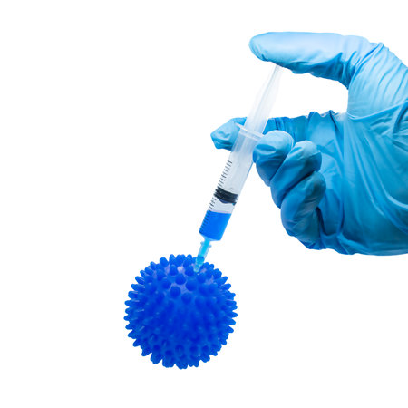Hand in blue medical glove with syringe and coronavirus isolated on white background. High quality...