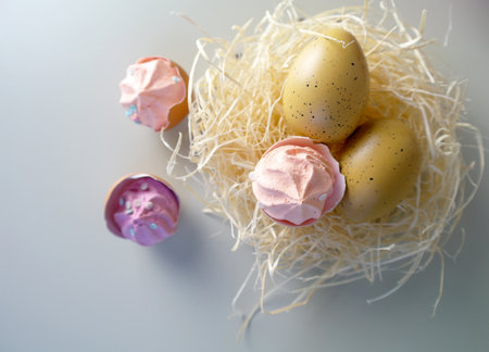 Bird eggs in a nest and Pink Meringues in eggshells, easter spring still life, selective focus, copy...