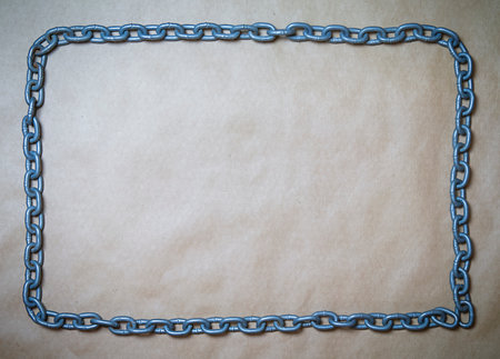 Frame made of metal chain on a textured brown background, copy space. High quality photo