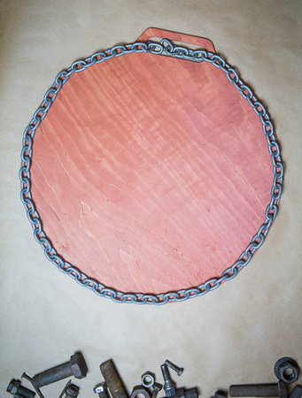 Round frame made of metal chain with a wooden background, copy space, top view, flatley. High...
