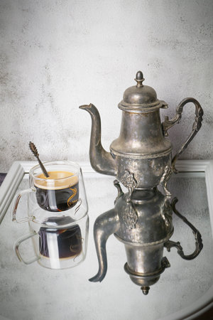 Coffee still life with a bowl, a coffee pot and reflections, selective focus, copy space. High quality photoの写真素材