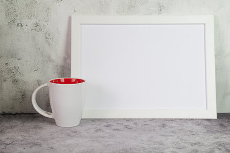 Minimalist interior with white mug and photo frame mockup. High quality photoの写真素材
