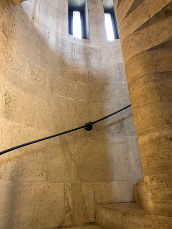 spiral stone staircase with railings in a high tower. high quality photoの写真素材