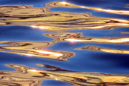 abstract nature background, water surface with waves at sunsetの写真素材