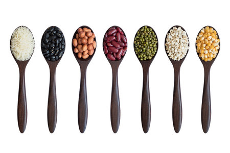 set of beans,peas,lentils,corns,rices on wooden spoons isolated on white background