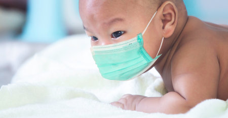 portrait of cute Newborn baby lay prone Was playing on the white mattressの写真素材